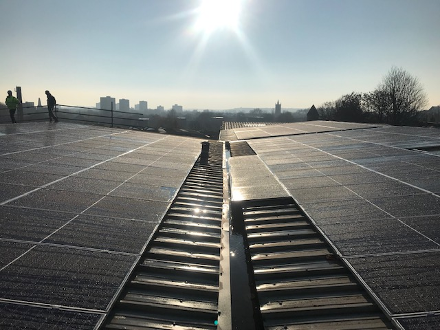 View across the solar panel installation on the facility roof